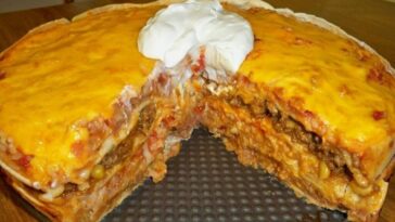 Golden-brown top layer of Tortilla Casserole in a baking dish.