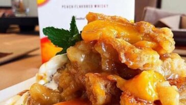 Golden-brown Crown Royal Peach Cobbler fresh out of the oven.