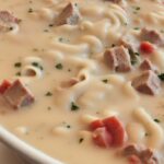 Final garnishing of Alfredo Lasagna Soup with Parmesan cheese.