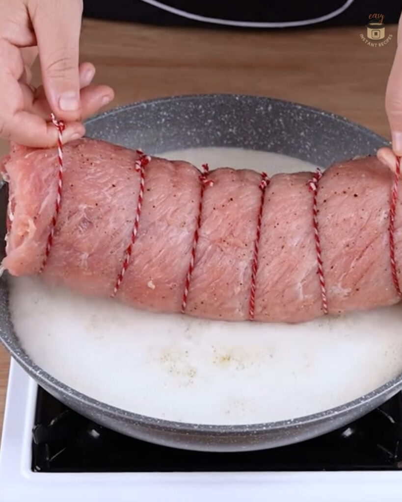 Restaurant-Style Pork Loin perfectly roasted with garlic and rosemary, showcasing a gourmet home-cooked meal high in protein.