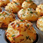 Get ready to fall in love with these Cheesy Mashed Potato Puffs! Mix 3 cups of chilled mashed potatoes with a large egg, 1 cup shredded cheddar, chopped chives, flour, garlic powder, salt, and pepper. Shape into 1-inch balls, coat with Parmesan, and bake at 400°F for 15-20 minutes until golden and crispy. Perfectly cheesy and oh-so-delicious, these puffs are ideal for any snack time or party!