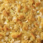 Homemade Chicken and Dressing Casserole is baked in a casserole dish with a golden cornbread topping.